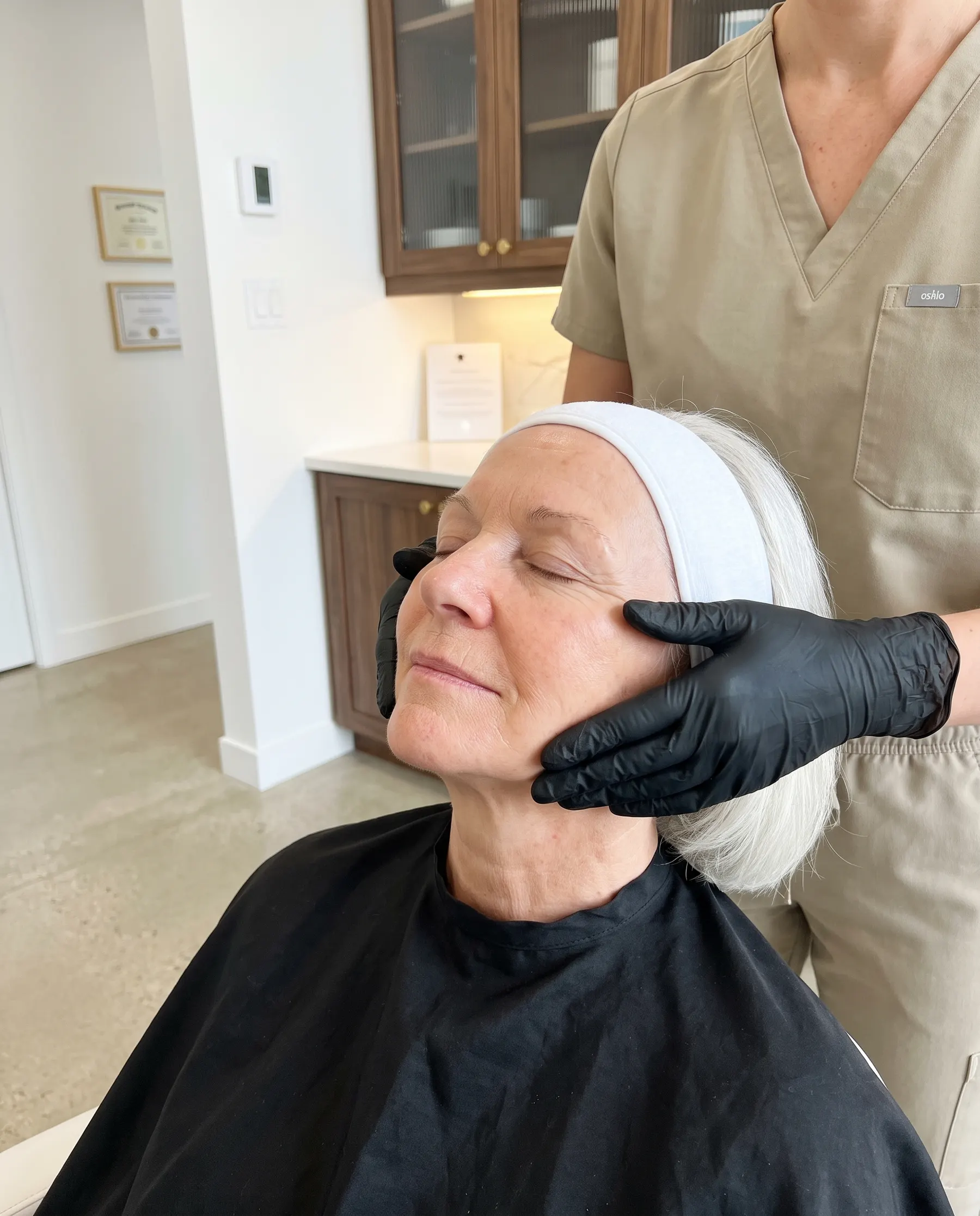A two-handed massage across the cheekbones, the client's eyes closed