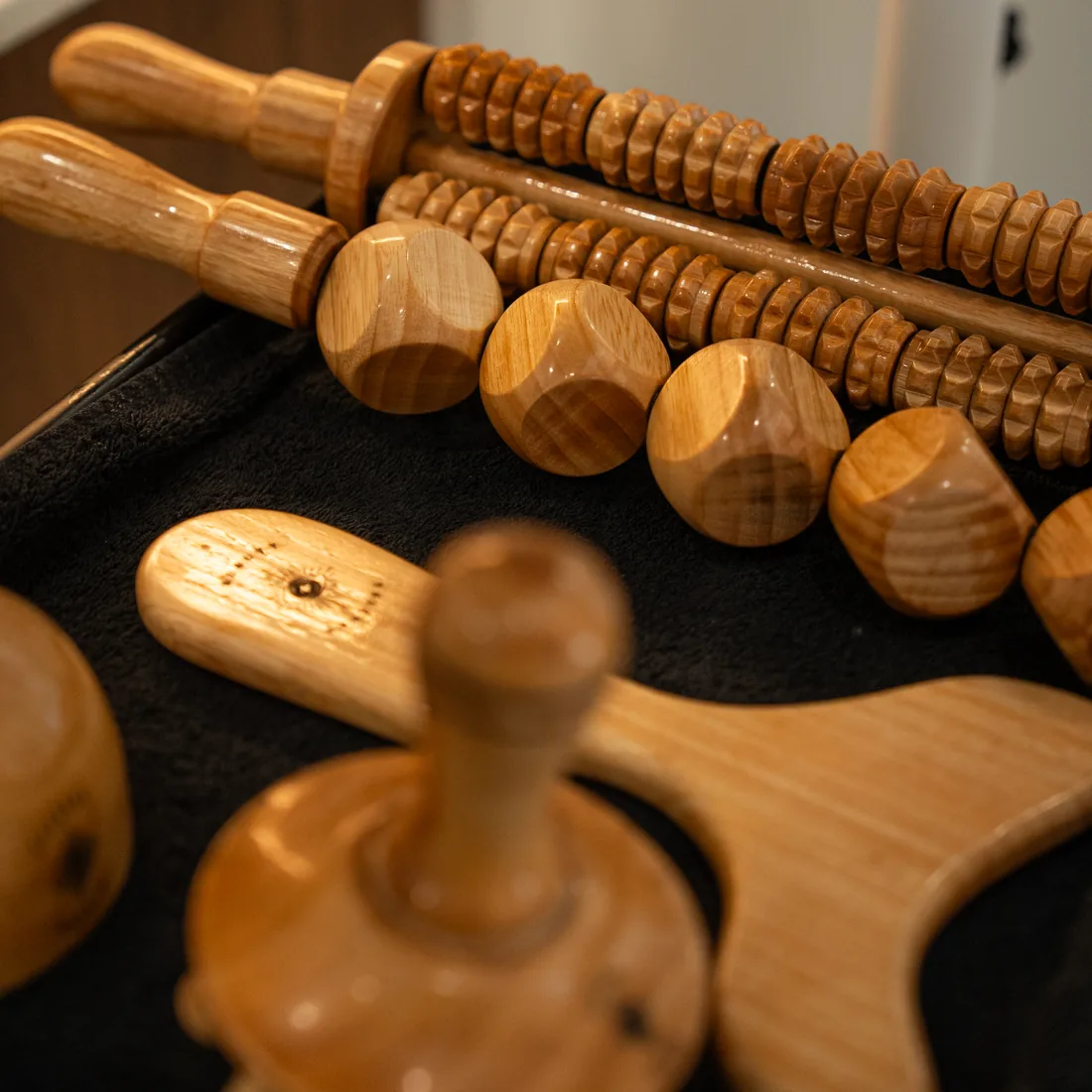The institute's wooden tools on their tray: textured rollers, cups and a shaping tool
