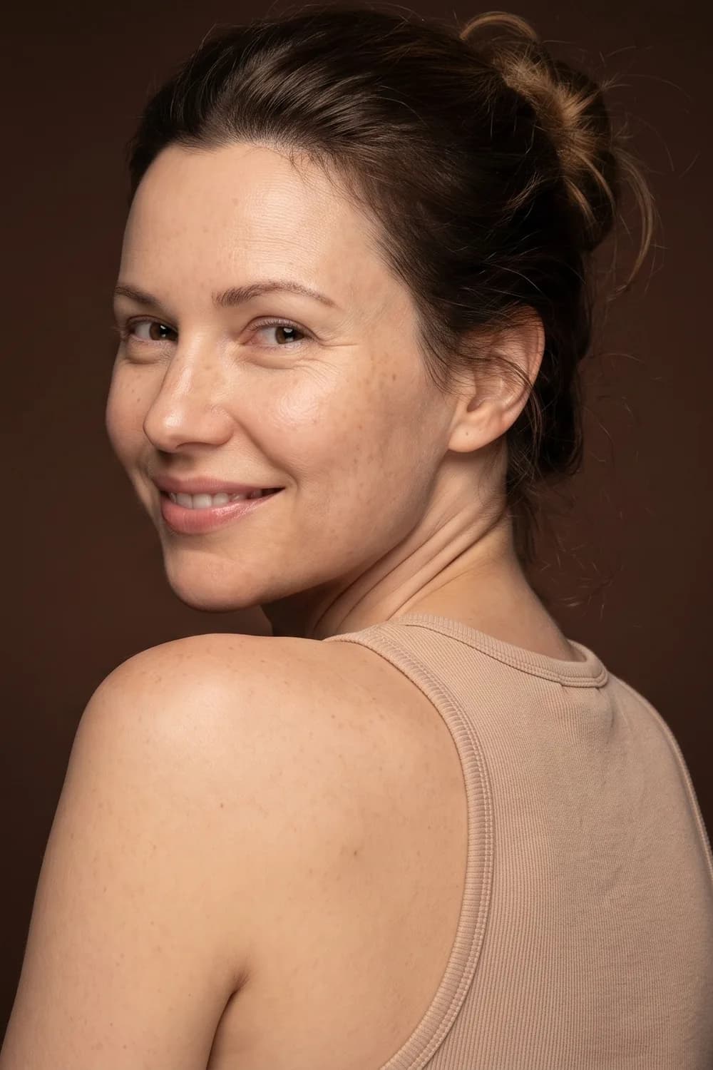 A woman smiling over her shoulder