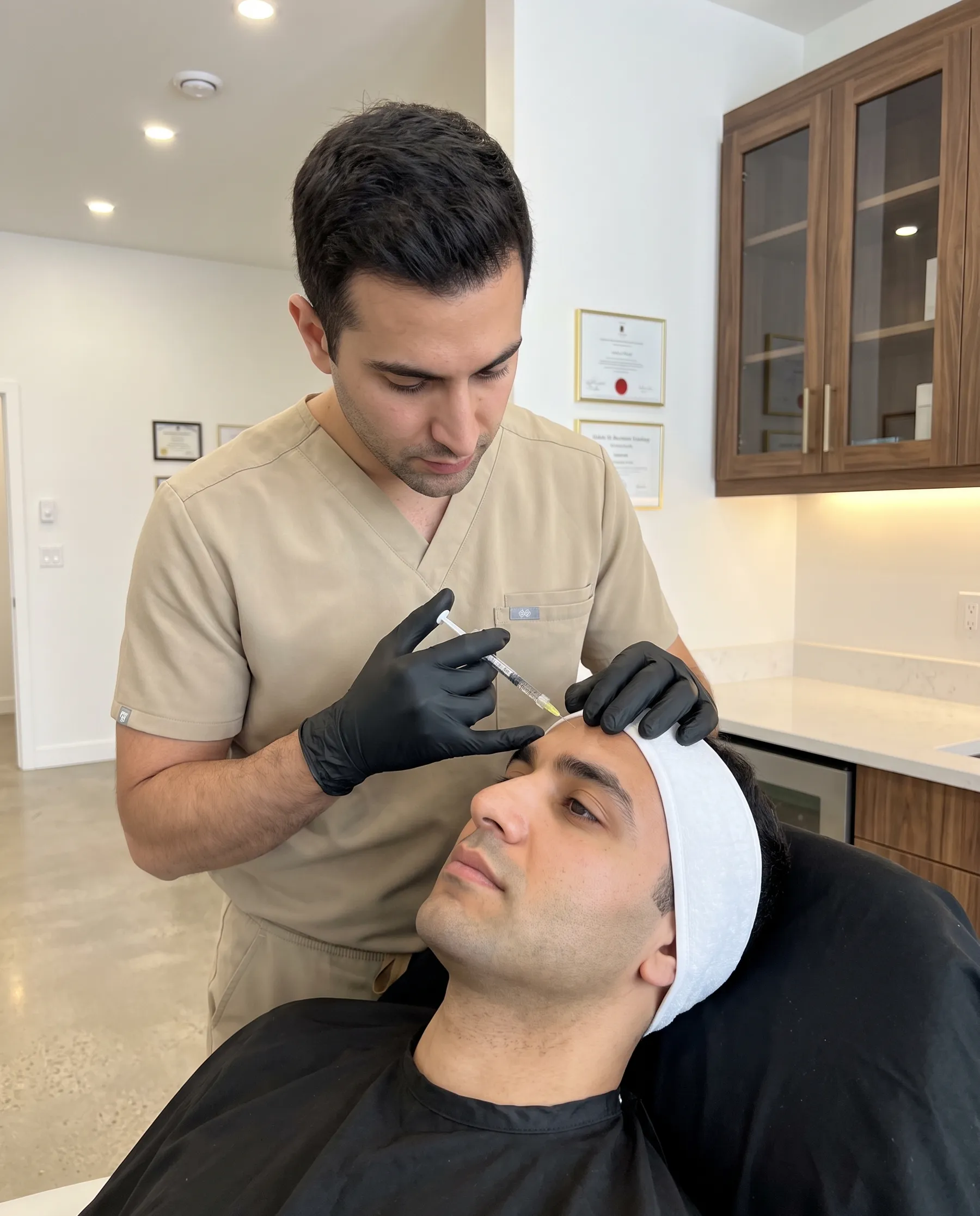 A physician's gloved hands, a fine syringe near a man's forehead