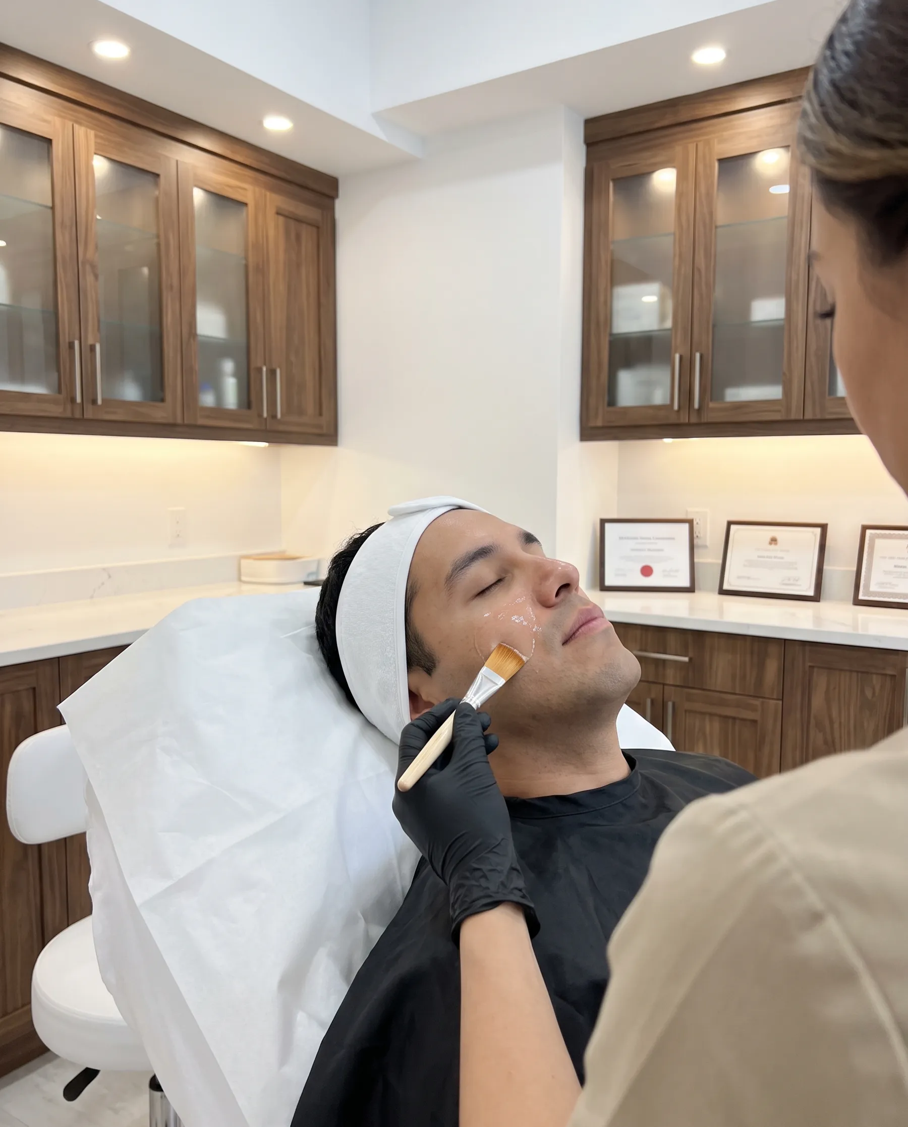 A treatment solution brushed across a man's cheek