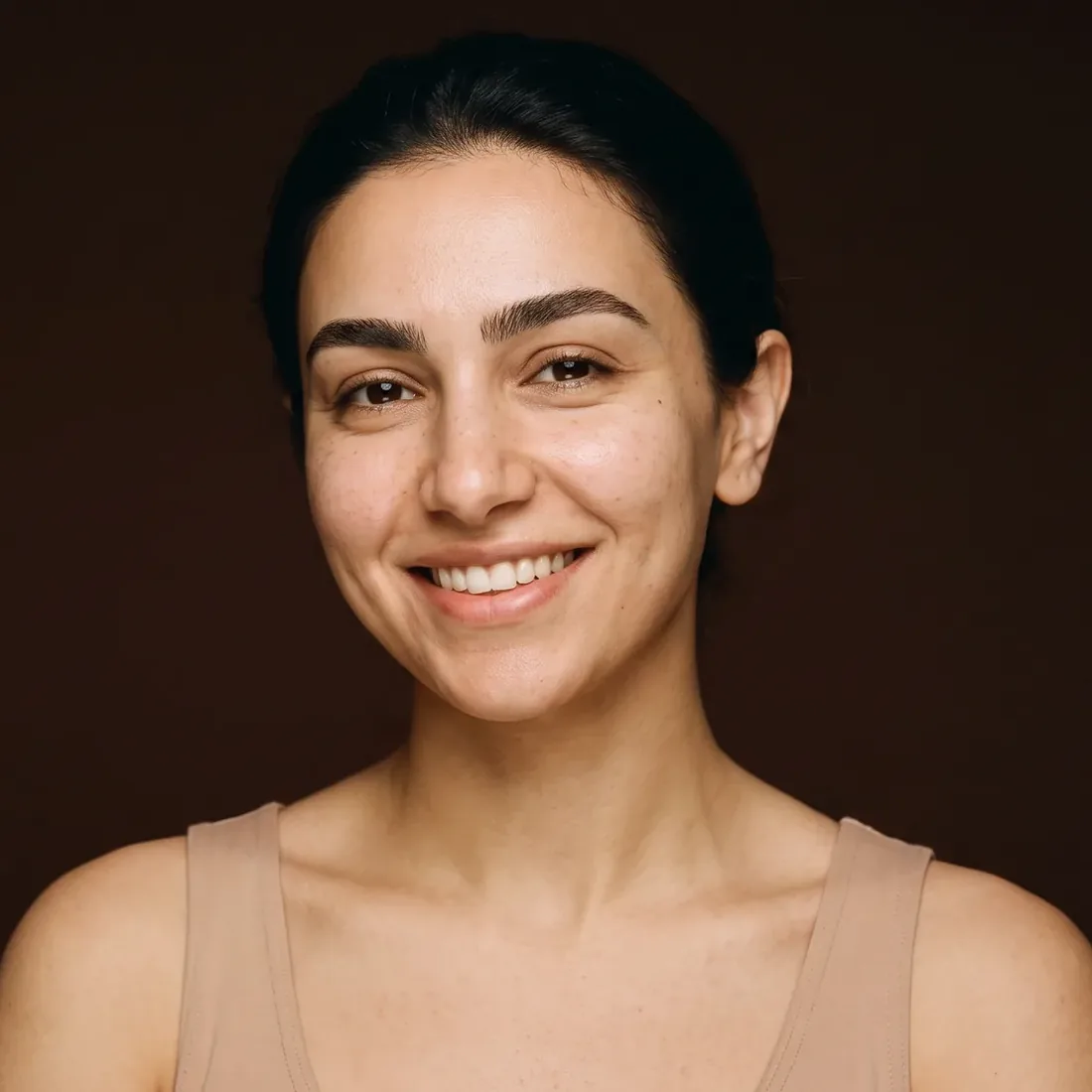 Smiling woman, bare face, naturally shaped brows