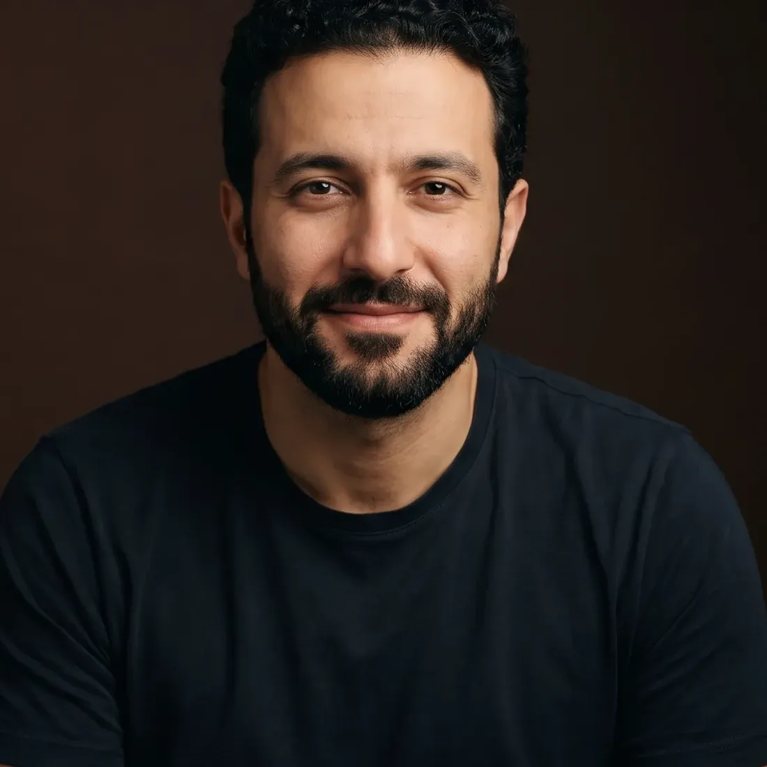 A man of about thirty-five with curly hair and a full beard