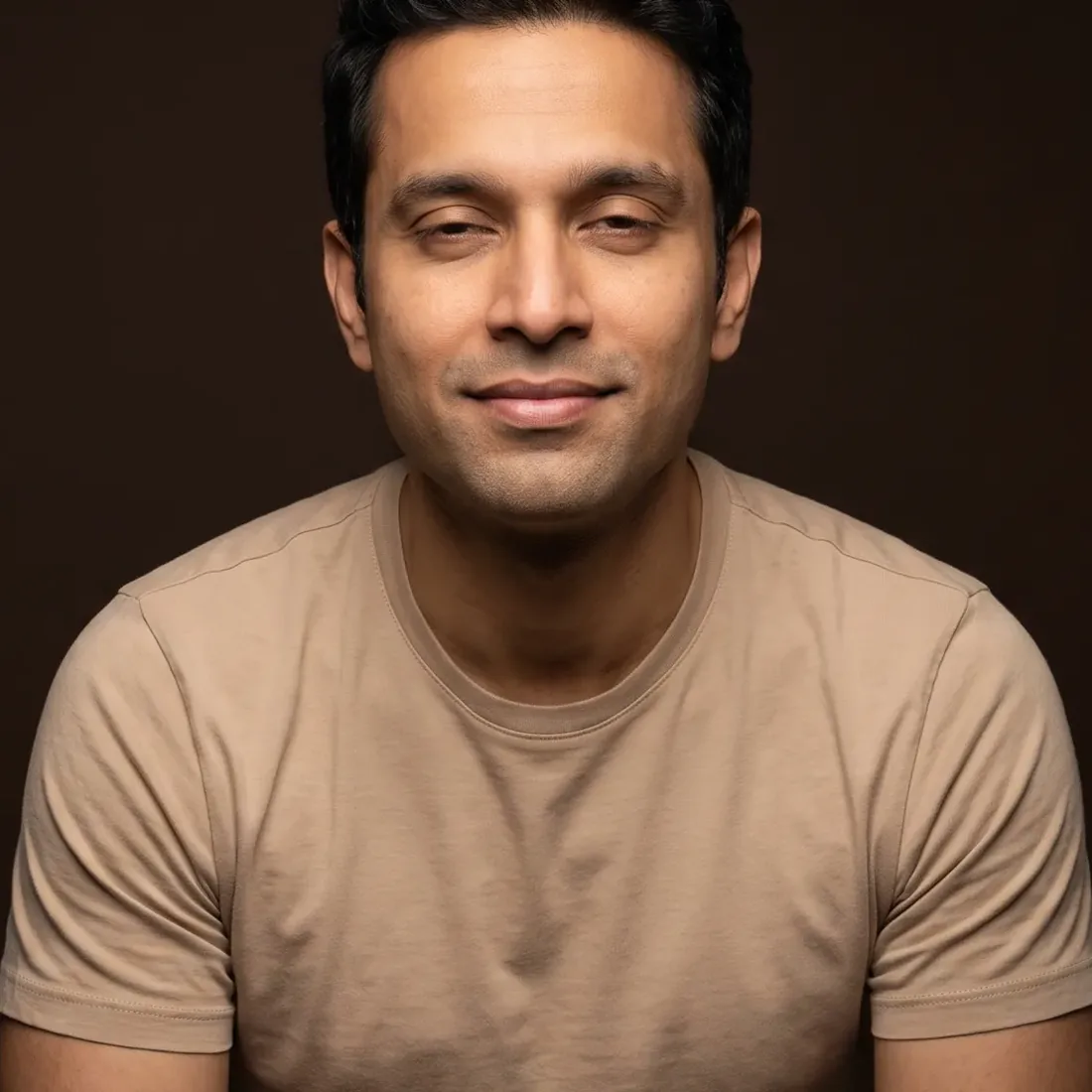 A man of about thirty-seven with dark hair, a serene face