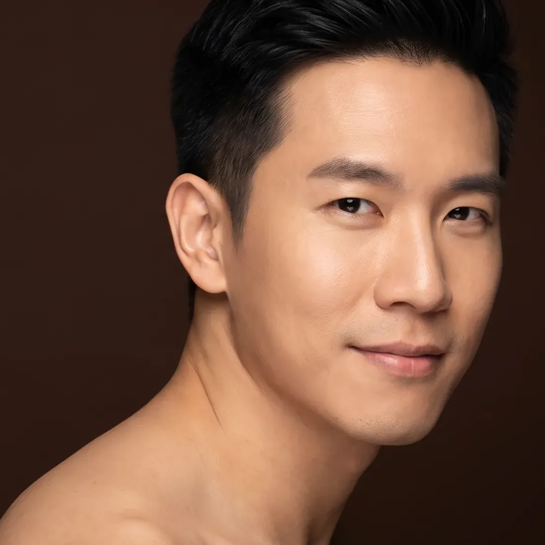 A man of about thirty-five, bare shoulders, turned back to camera