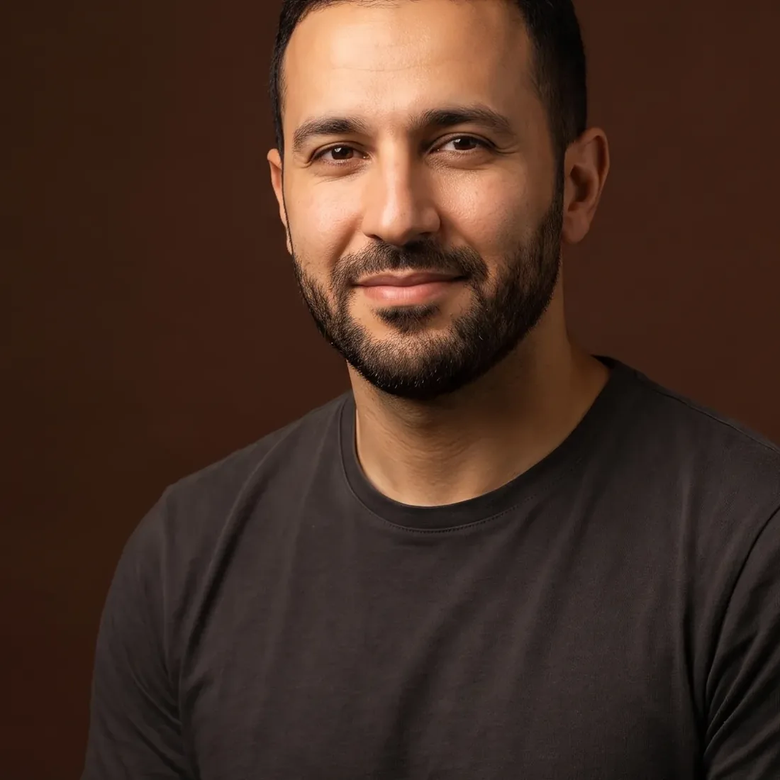 A man of about thirty-seven with dark hair and a short beard