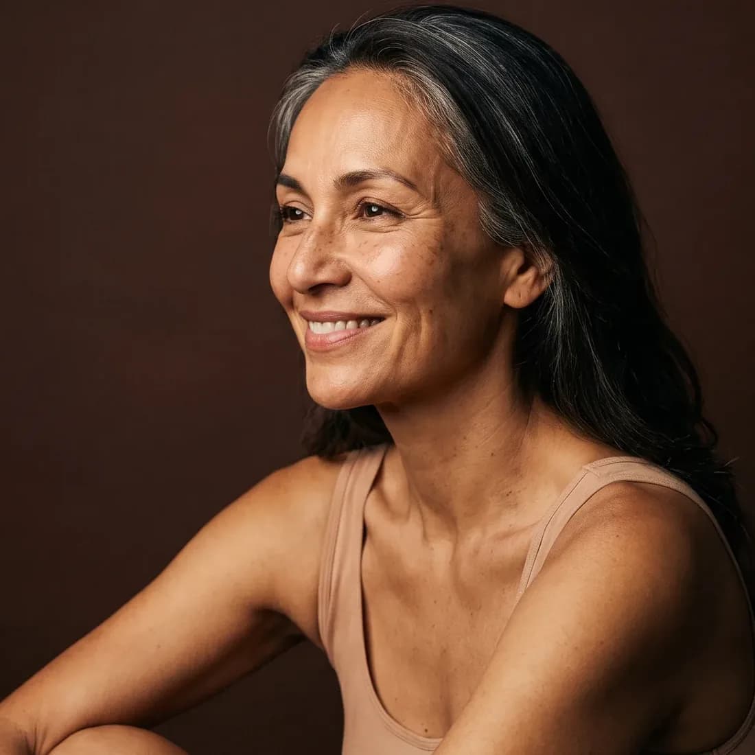 Woman in three-quarter profile, knowing smile, clear features