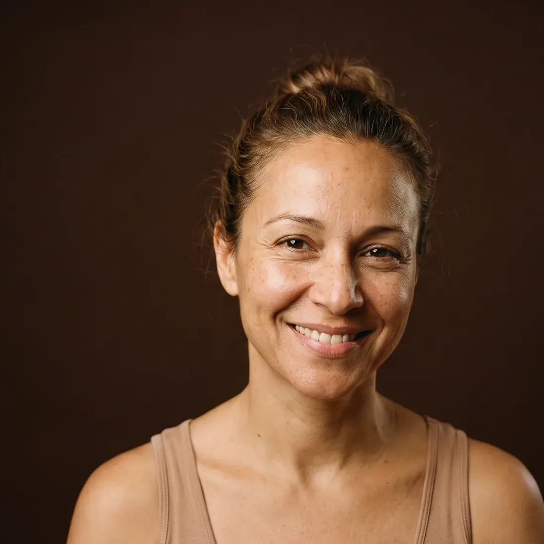 Woman with a clear gaze, rested eye area, warm smile