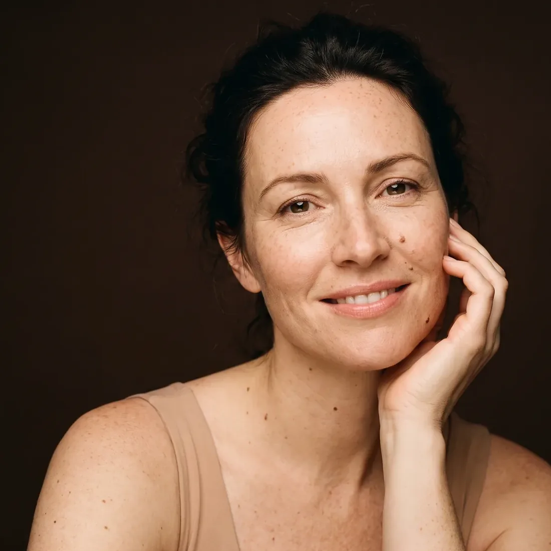 Smiling woman, luminous skin, fine lines left visible