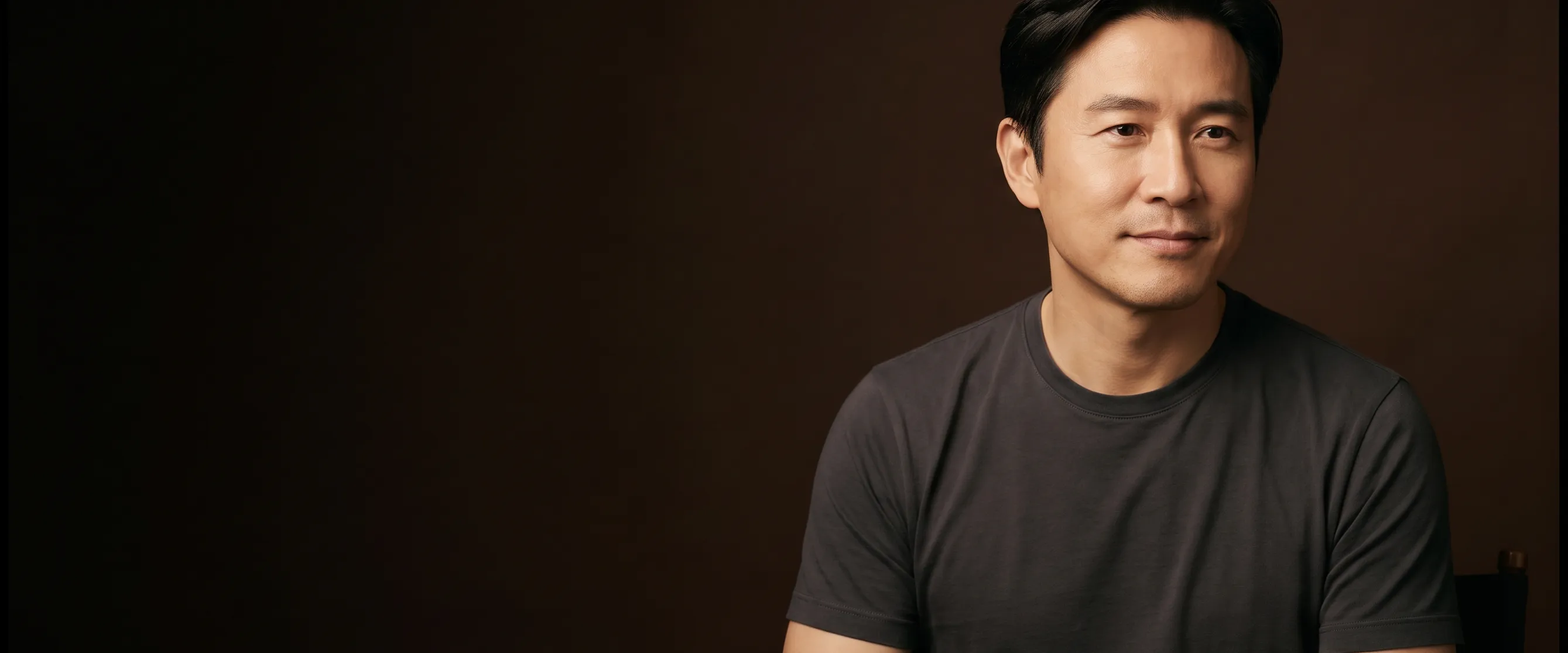 A man of about forty with side-parted black hair