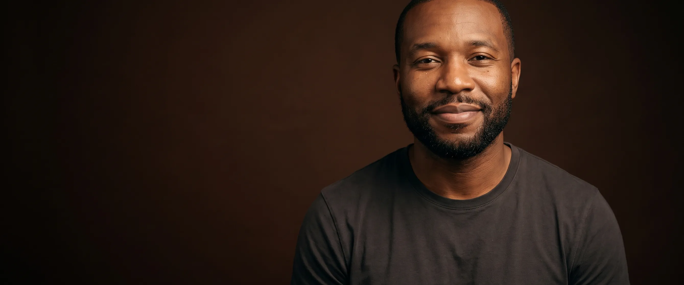 A man of about forty with short hair and a neat beard