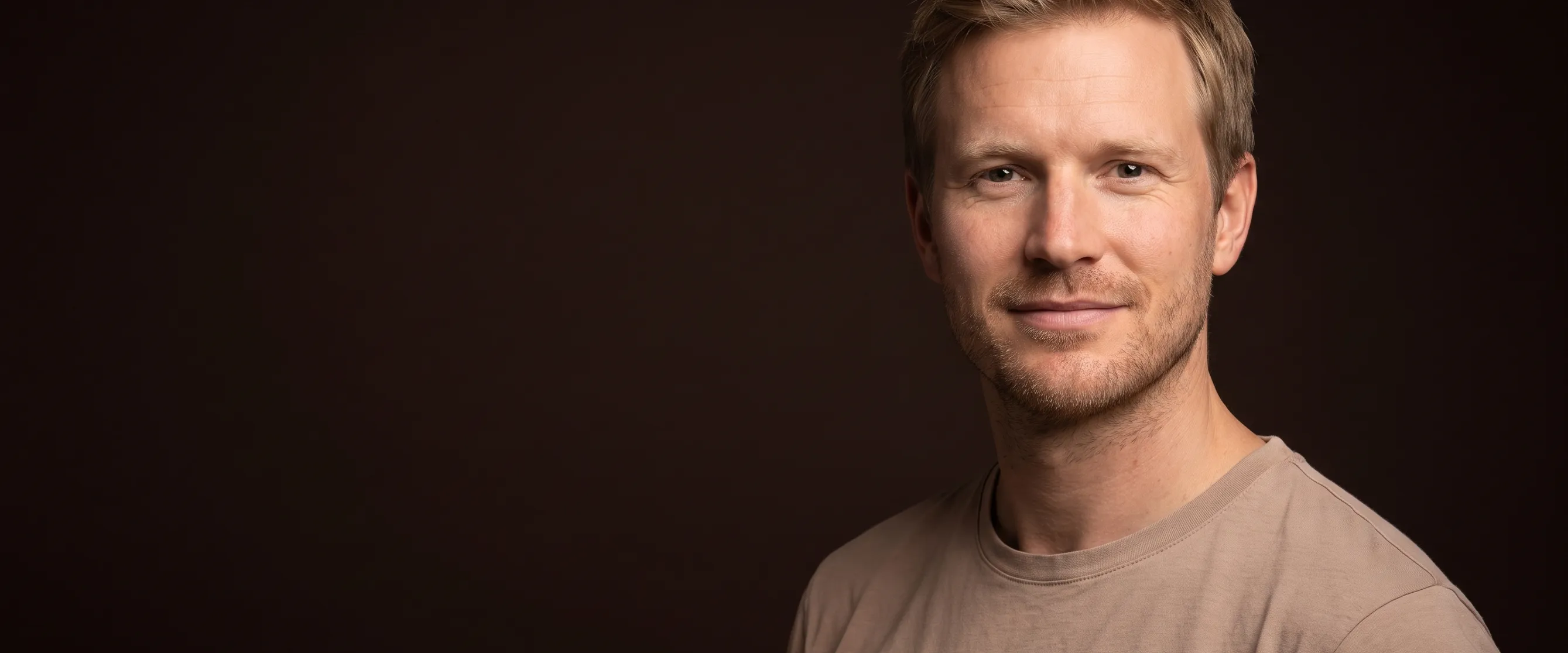 A man of about thirty-eight with sandy blond hair and stubble