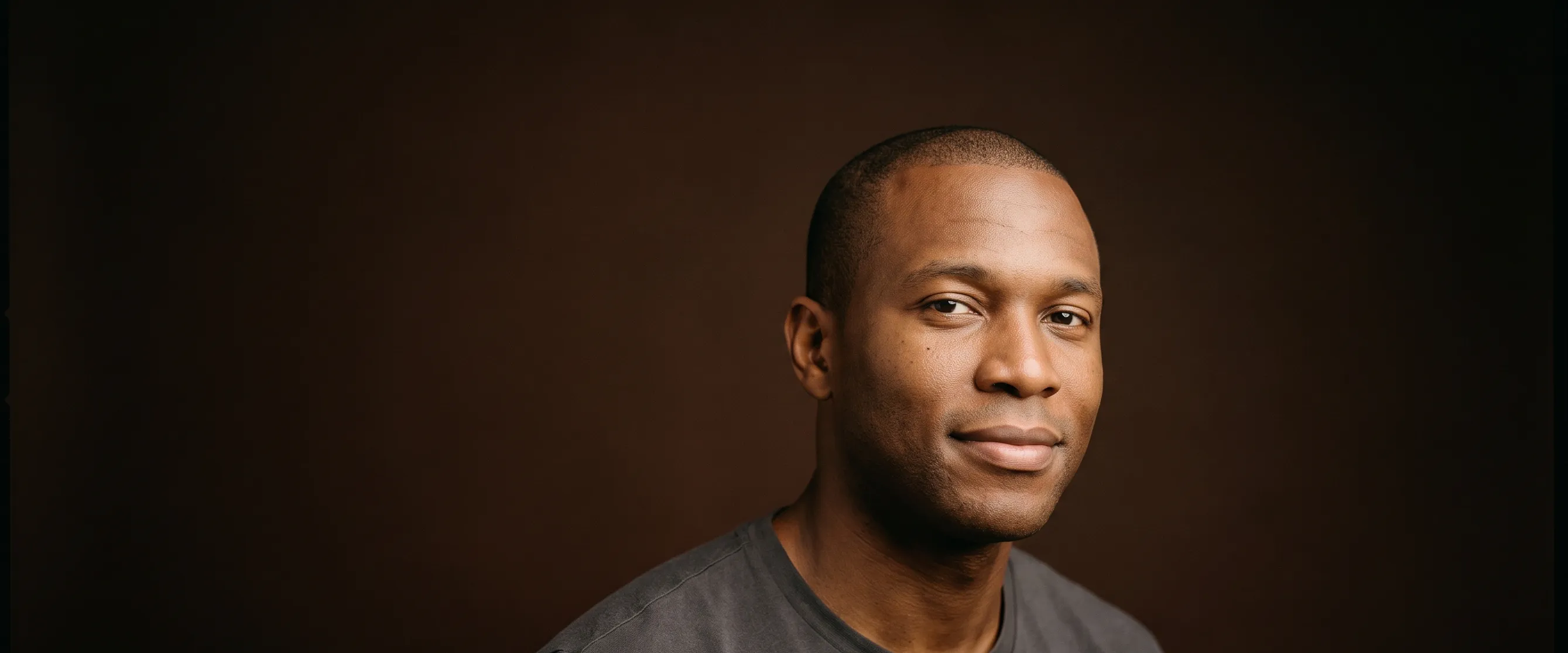 A man of about thirty-six with close-cropped hair, a calm gaze
