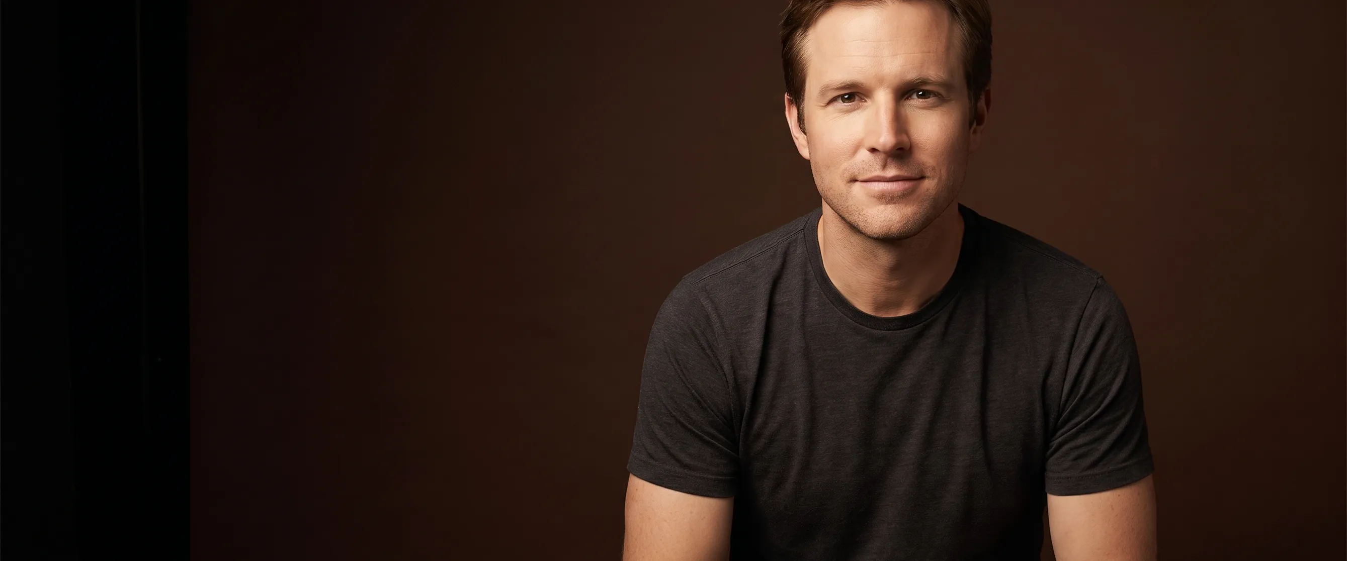 A man of about thirty-nine with light brown hair, clean-shaven