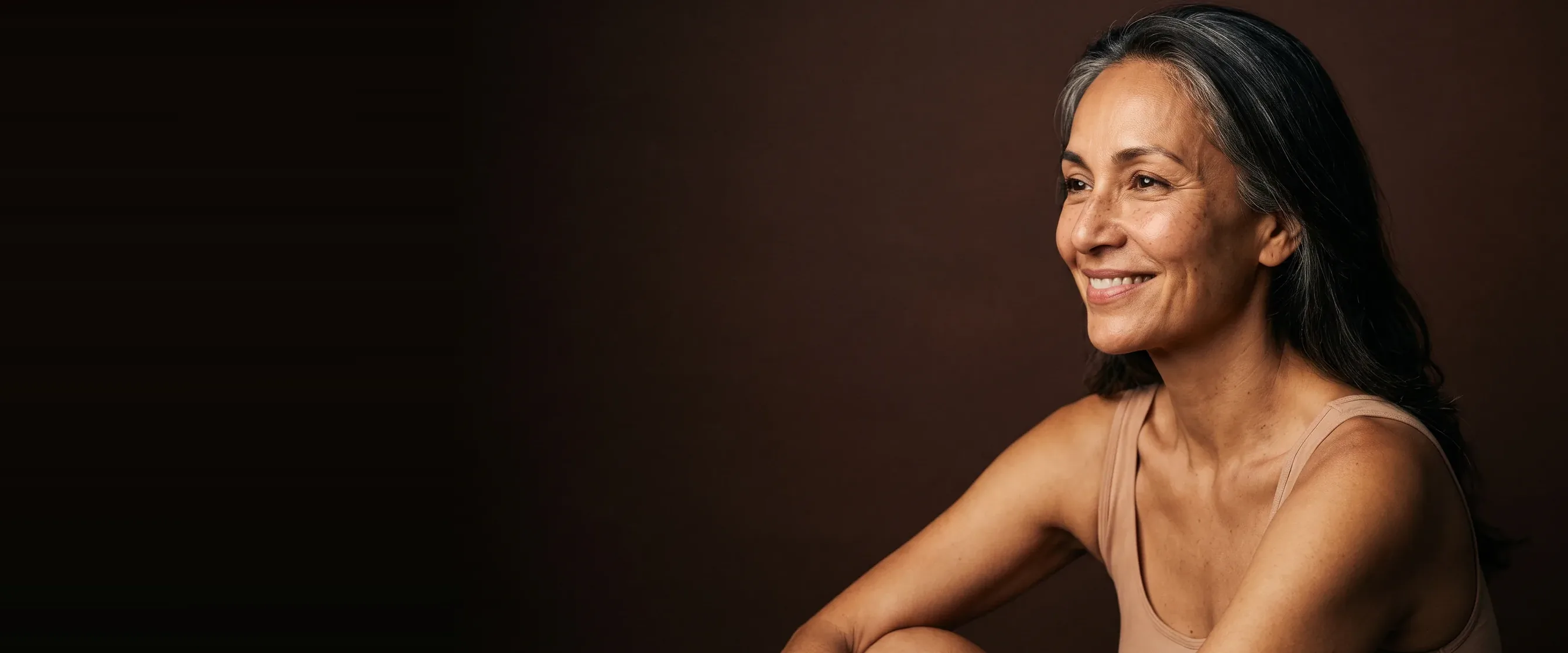 A woman in three-quarter profile, a knowing smile, features sharp