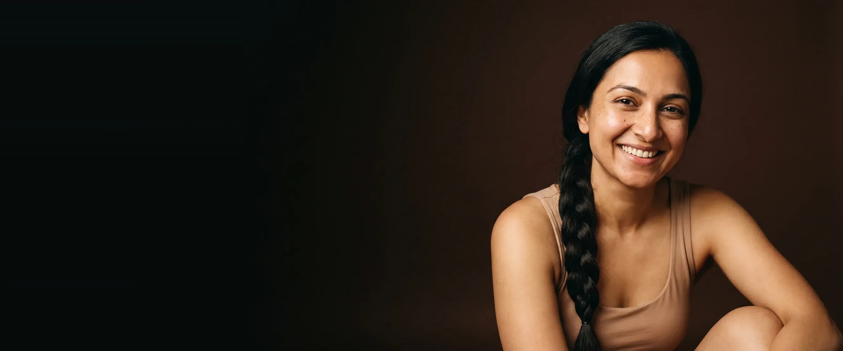 A woman with a long braid, a calm and radiant smile
